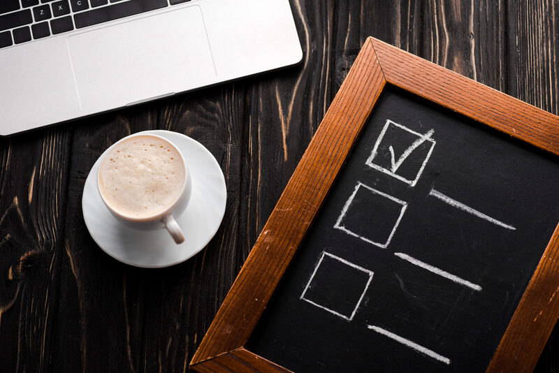 A practice manager checking off items on a software requirements checklist